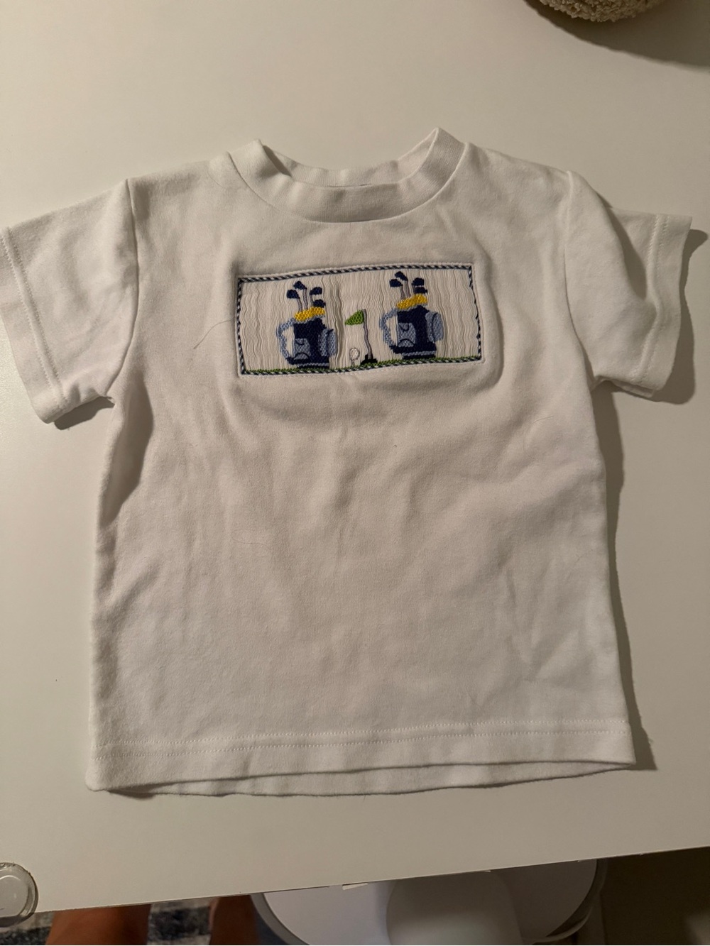 Hand smocked golf tee